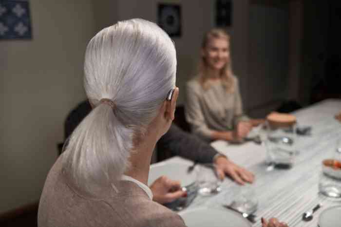 family at the table with grandmother wearing a hearing aid
