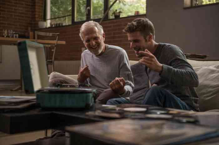 grandpa and nephew using a turntable together.