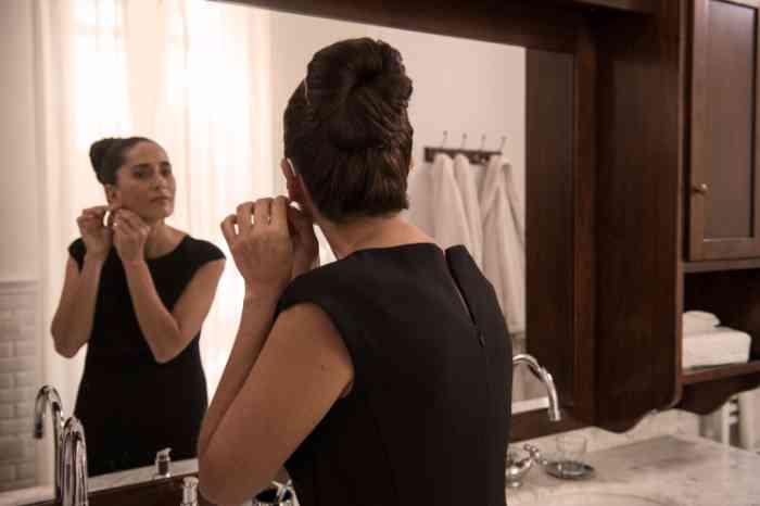 woman wearing hearing aids getting ready in the bathroom.