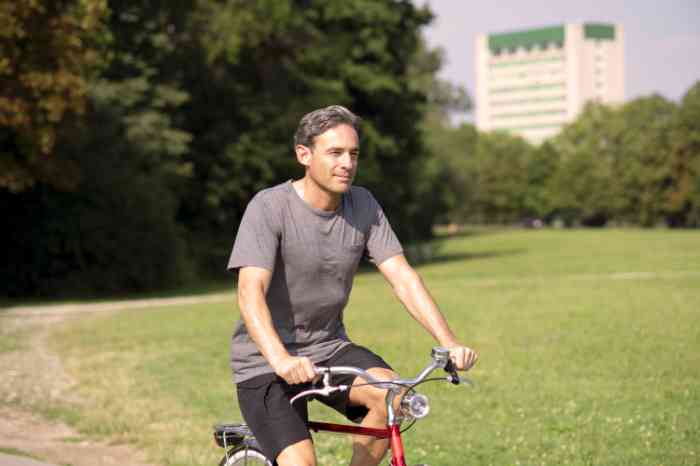 man riding a bike in the park.