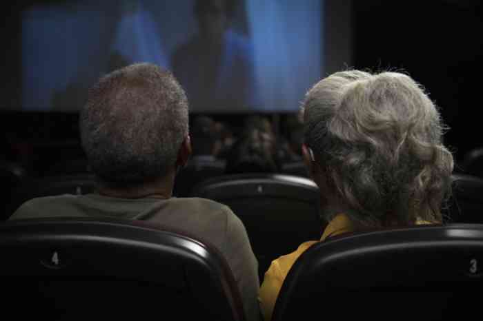 A couple watching a movie at the cinema