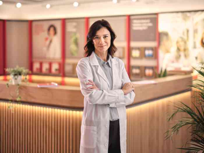 female audiologist portrait wearing a coat.