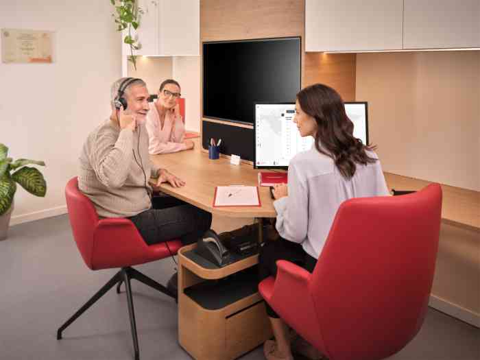 a couple taking a hearing test with an audiologist without lab coat.