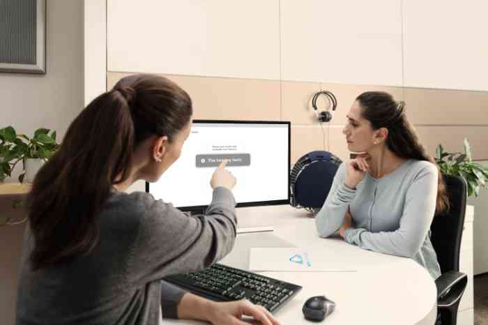 A Grandma and her Grandson playing together on a bed