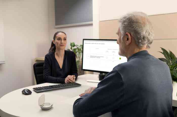 A man talking to an Amplifon professional.