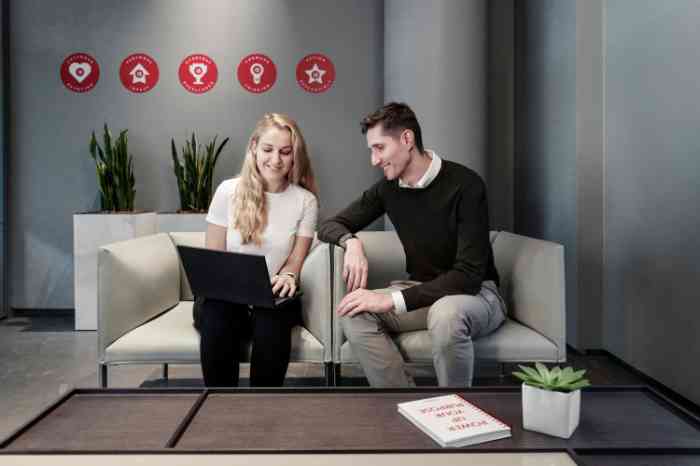 A twosome reading a book together in bed