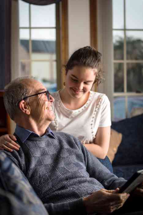 A woman wearing her hearing aid before going to bed