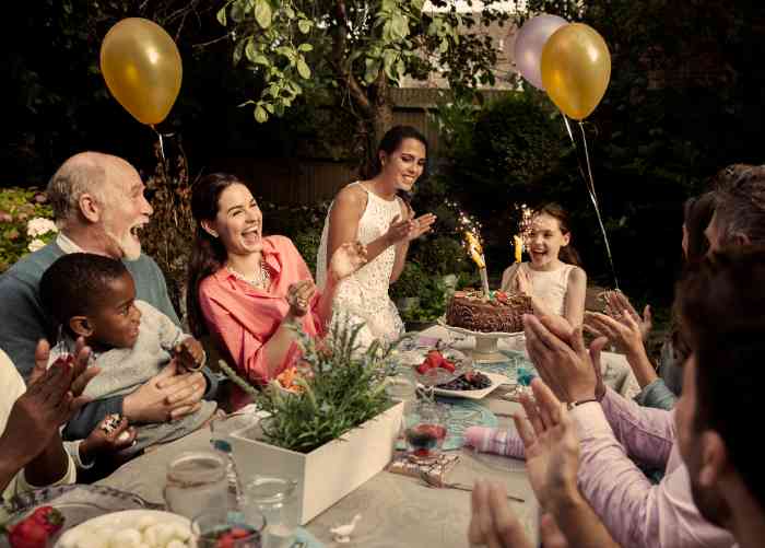 family celebrating a birthday around a table.