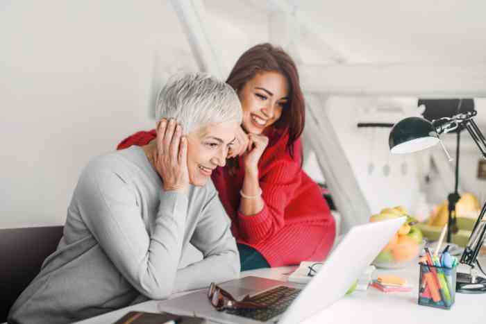 mother and daughter looking at a computer.