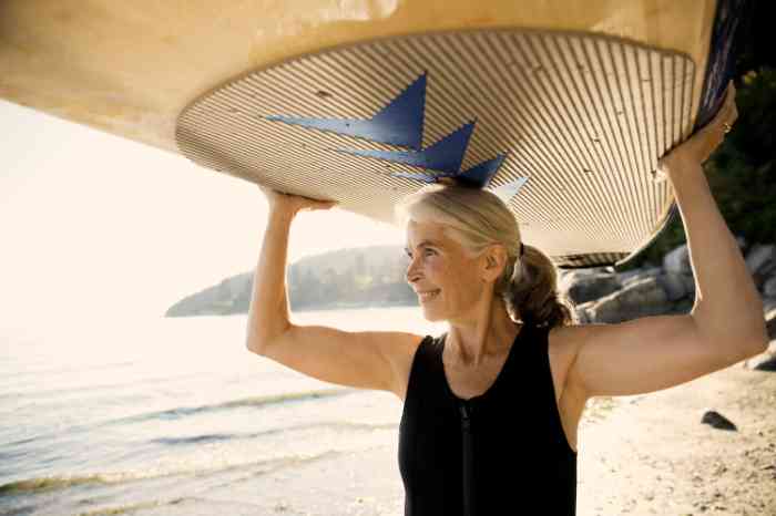 A woman is going surfing wearing her hearing aid