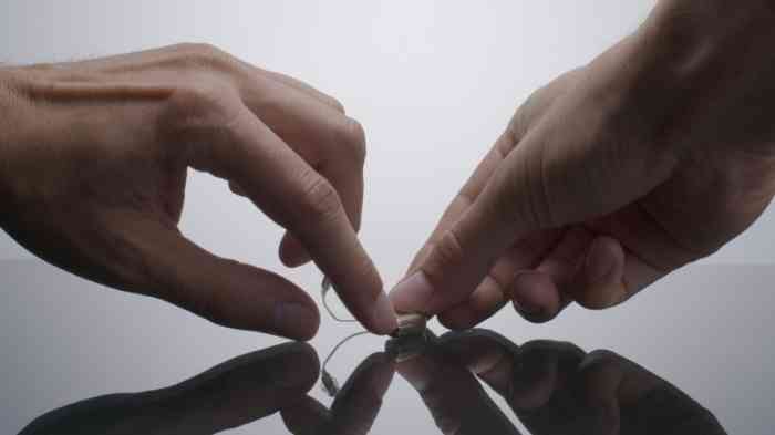 Switching on a small RIC hearing aid